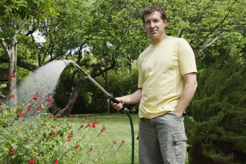 Trained gardeners using protective equipment during maintenance work